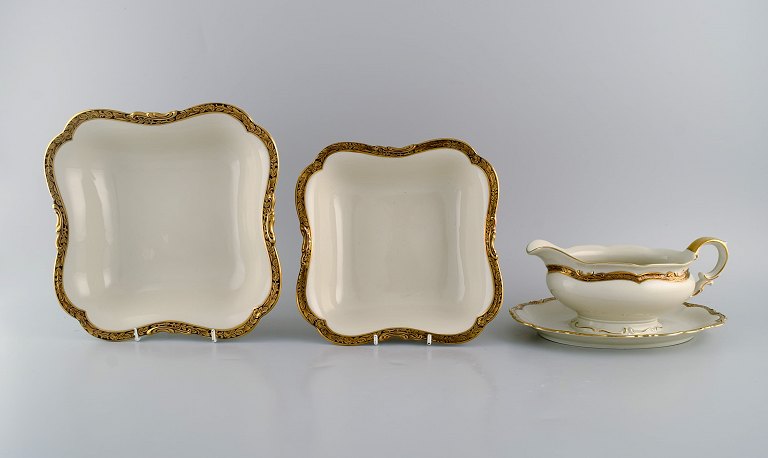 KPM, Berlin. Royal Ivory sauce boat and two bowls in cream-colored porcelain 
with gold decoration. 1920s.
