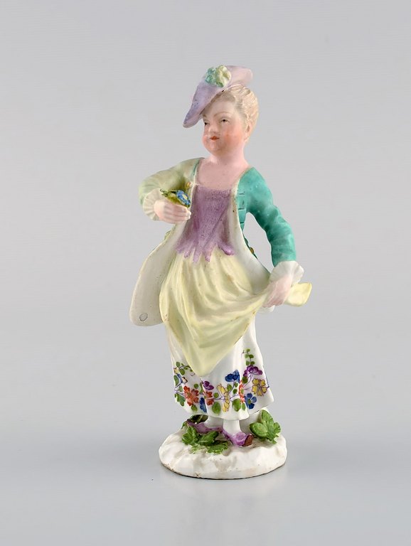 Meissen, Tyskland. Antik håndmalet porcelænsfigur. Dame med blomster. Sent 1800-tallet.