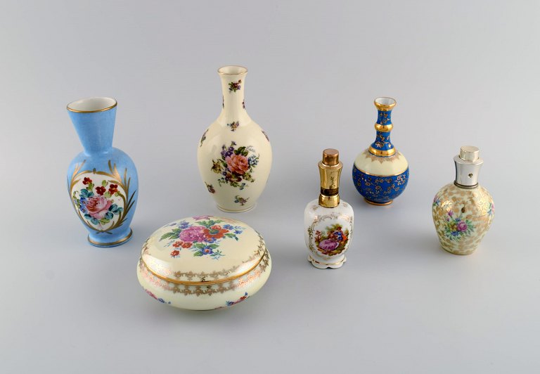 Limoges, France. Two perfume bottles, three vases and lidded box in hand-painted porcelain. Flowers and gold decoration. 1930s / 40s.