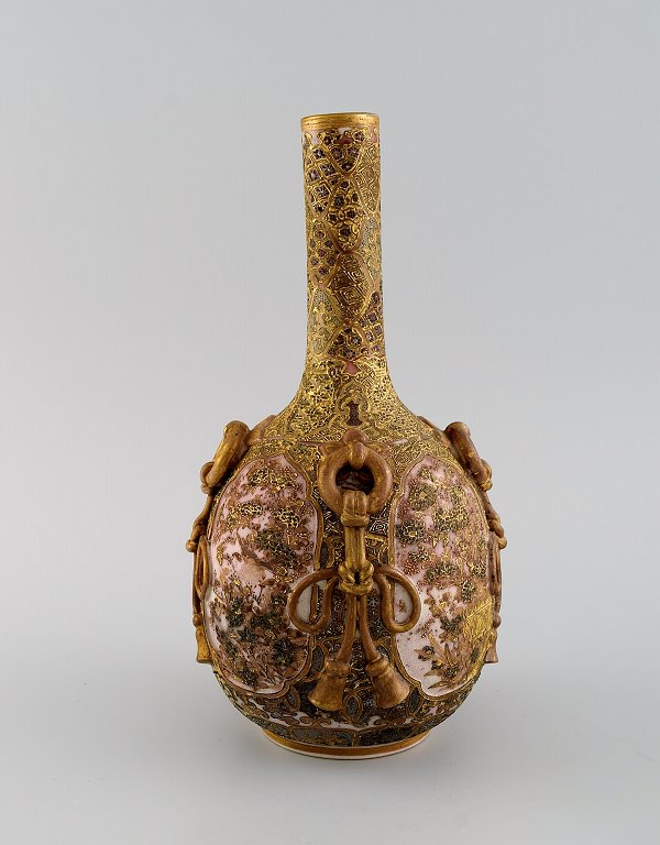 Meiji (1868–1912). Japanese satsuma bottle vase decorated in colors and gold with flowers in light relief.