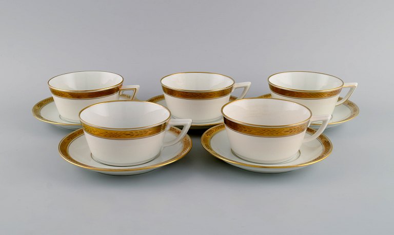 Royal Copenhagen service no. 607. Five teacups with saucers. Gold border with foliage. 1960s. Model number 607/9536.