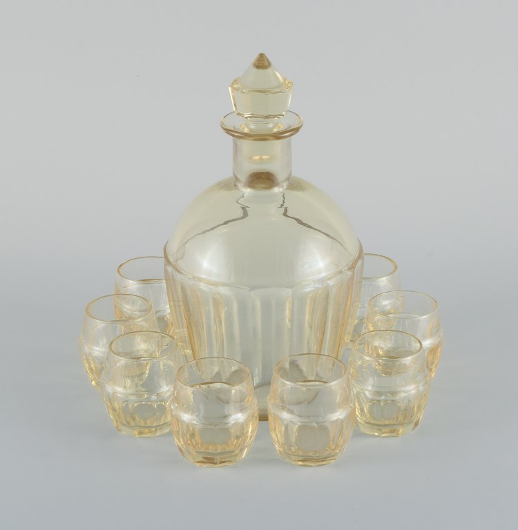 Daum, France, art deco decanter and set of eight liqueur glasses in faceted smoke colored art glass.