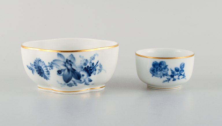 Meissen, two bowls hand painted with blue flowers and gold rim.Late 19th century.