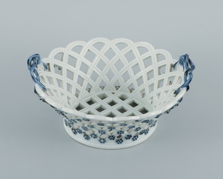 Meissen, Germany. Rare and early Meissen bowl with pierced rim, handle in the form of branches and foliage. Pushing flowers in relief.