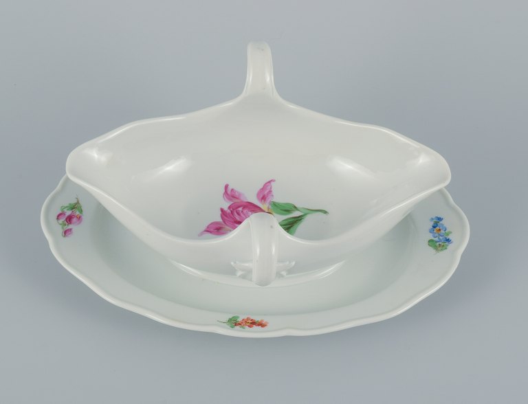 Meissen, Germany, sauce pot on foot hand painted with floral motifs in different colors.