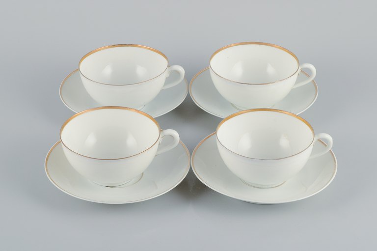Rosenthal, Germany, a set of four large teacups and matching porcelain saucers. Thin white porcelain with gold decoration.