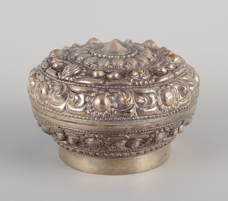 Chinese silversmith. Lidded jar richly decorated in relief with flowers and ornaments.
