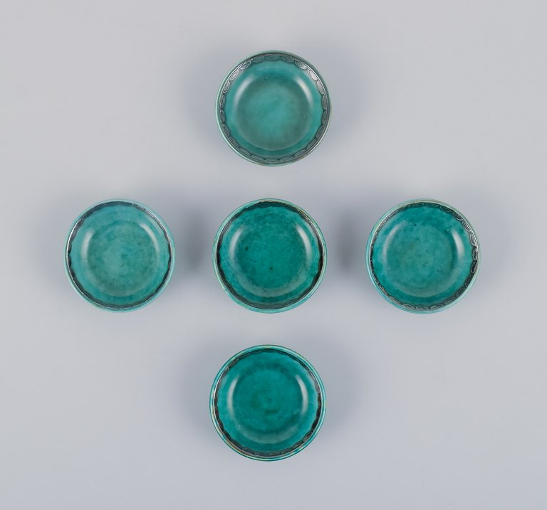 Wilhelm Kåge for Gustavsberg, a set of five small "Argenta" ceramic bowls. Green glaze with silver inlays.