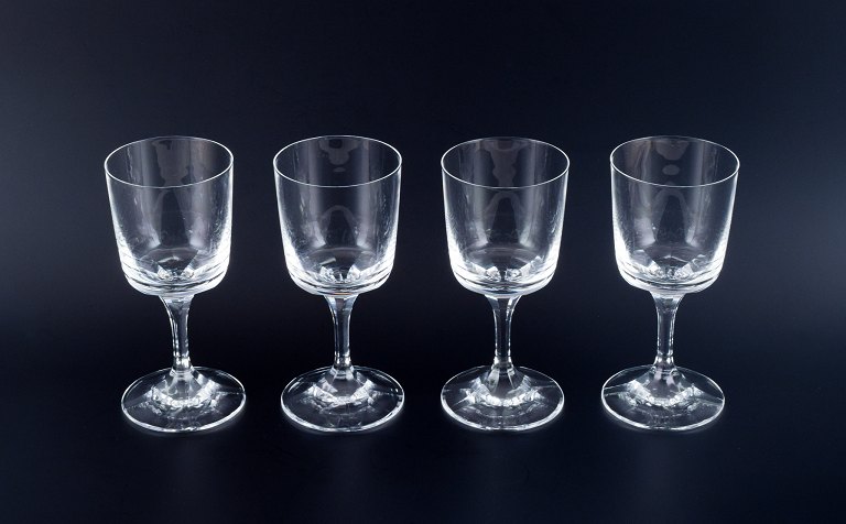 A set of four René Lalique Chenonceaux red wine glasses.Clear mouth-blown crystal glass with facet-cut stem.