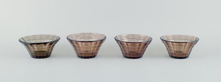 Simon Gate (1883-1945) for Orrefors/Sandvik, Sweden.A set of four Art Deco bowls in smoked coloured pressed glass.