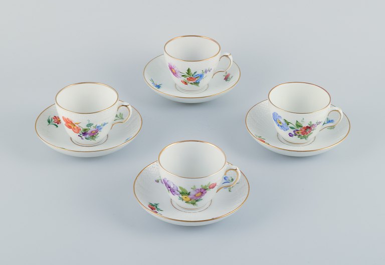 Royal Copenhagen, Saxon Flower, a set of four coffee cups with saucers, hand-decorated with polychrome flowers and gold rim.