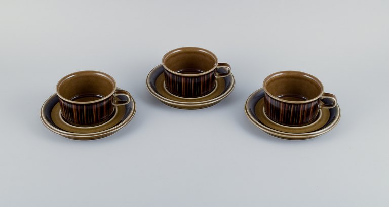 Gunvor Olin-Grönqvist for Arabia, "Cosmos," three sets of tea cups with  saucers. Stoneware in a retro style. Glazed in green-brown tones.