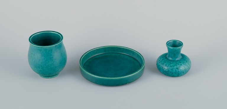 Wilhelm Kåge (1889-1960) for Gustavsberg, Sweden. Two Art Deco vases and a low bowl in ceramic with classic green glaze. From the Argenta series.