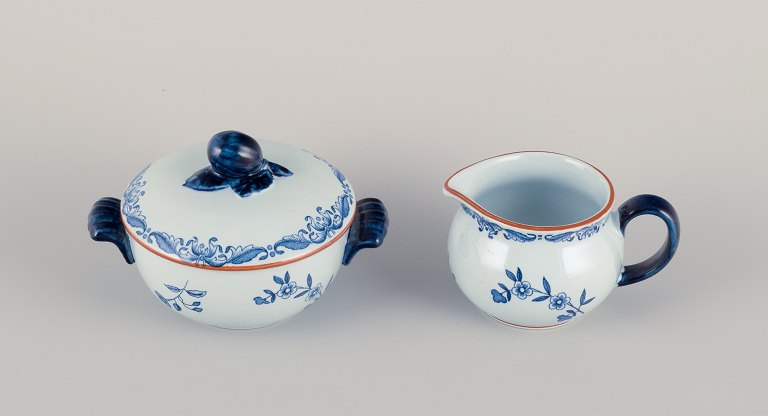 Nils Emil Lundström for Rörstrand, Sweden, "Ostindia" sugar bowl and creamer in faience with flower motifs.