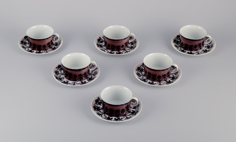 Bjørn Wiinblad for Rosenthal, Germany. A set of six "Berlin Hilton" coffee cups with saucers in porcelain. Glossy copper-colored decoration.