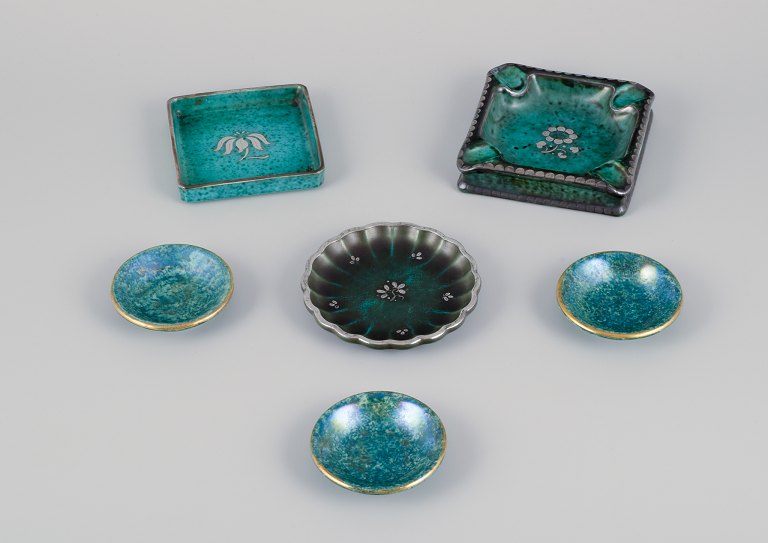 Wilhelm Kåge & Josef Ekberg for Gustavsberg, Sweden. A set of six ceramic dishes in different sizes. Flower motifs inlaid in silver.