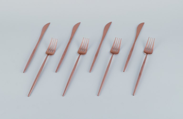 A four-person modernist dinner cutlery set in brass.Comprising four dinner knives and four dinner forks.
