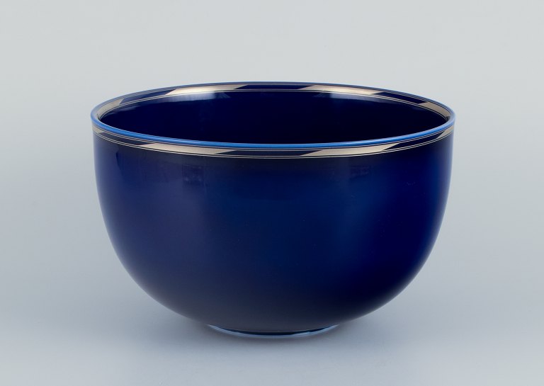 Alev Siesbye for Royal Copenhagen. Large porcelain bowl decorated with blue glaze and rim embellished with silver.