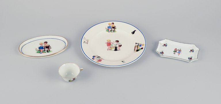 Limoges, Digoin & Sarreguemines, France. Childrens porcelain dinnerware consisting of a plate, two small dishes, and a cup. Motifs of children at play.