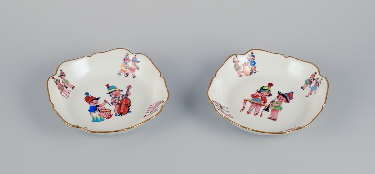 Limoges, France. Two deep childrens plates in porcelain. Gold rim. Motifs of child musicians.