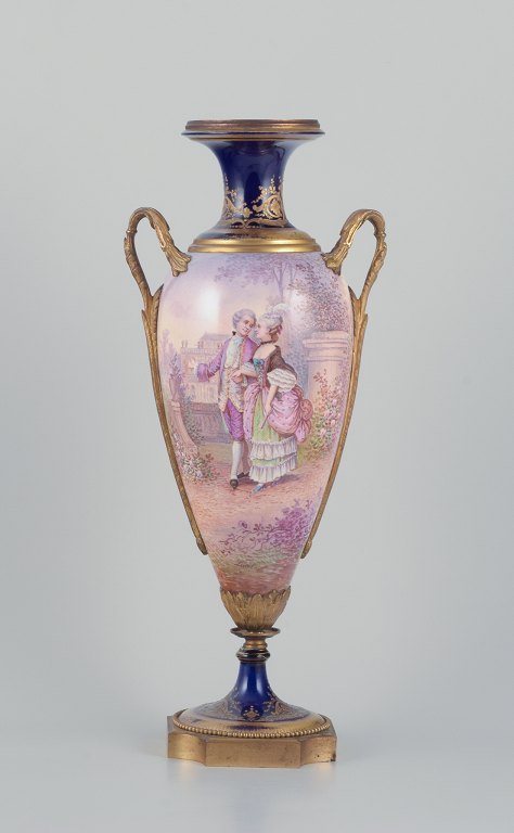 Lucot for Sevres, France. Large amphora-shaped urn in faience and bronze. Sevres Bleu decoration with gold accents. Scene Galante. Hand-painted.