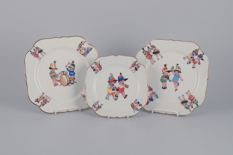 Limoges Porcelaine, France. Three porcelain plates with motifs of child musicians.