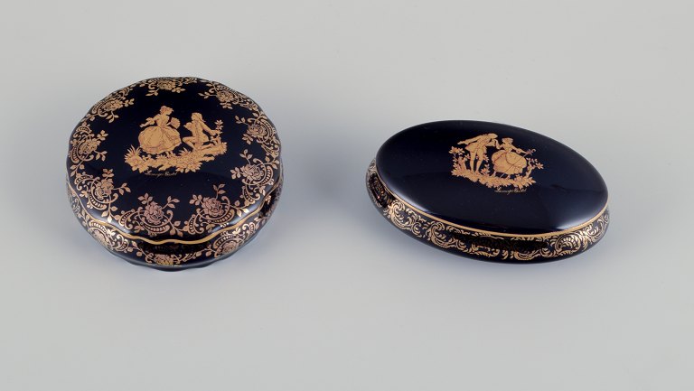 Limoges, France. Two covered jars in porcelain, one oval, decorated with 22-karat gold leaf and beautiful royal blue glaze. Scène galante.