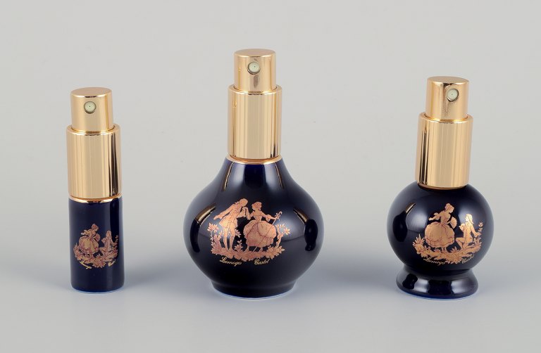 Limoges, France. Three porcelain perfume bottles, decorated with 22-karat gold leaf and a beautiful royal blue glaze. Scène galante.