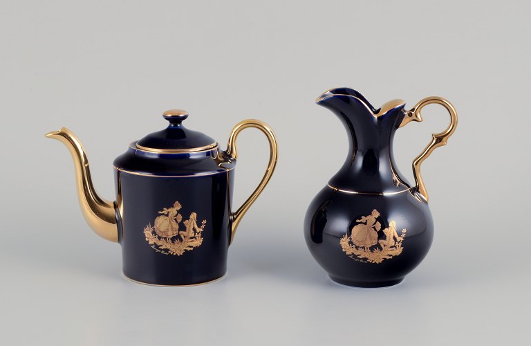 Limoges, France. Miniature Coffee pot and water jug in porcelain, decorated with 22-karat gold leaf and a beautiful royal blue glaze. Scène galante.