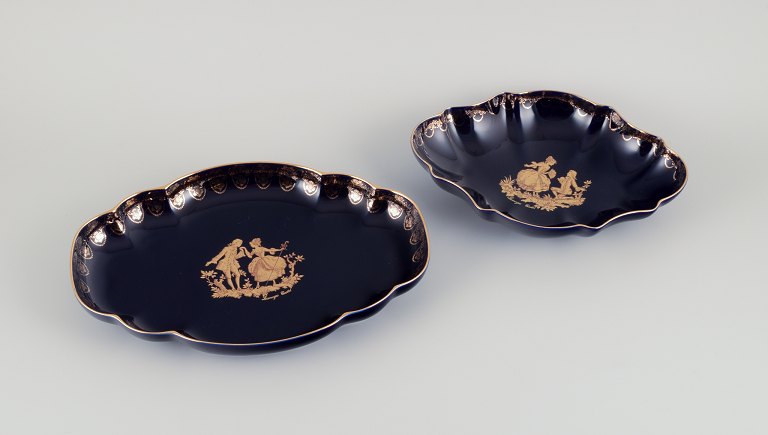 Limoges, France. Two porcelain serving platters adorned with 22-karat gold leaf and a beautiful royal blue glaze featuring Scène galante.