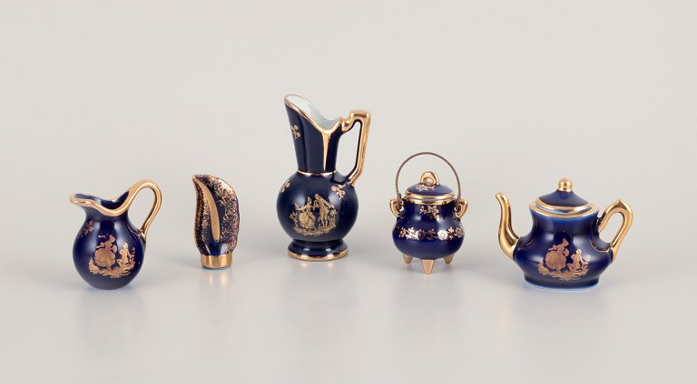 Limoges, France. Five pieces of miniature porcelain decorated with 22-karat gold leaf and beautiful royal blue glaze.