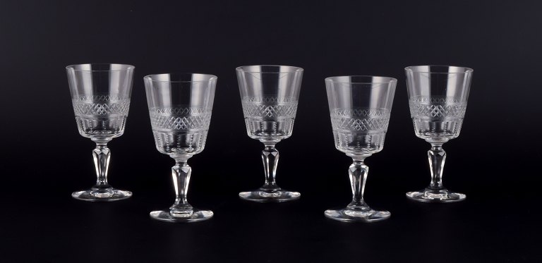 A set of five mouth-blown French white wine glasses in crystal glass. Faceted cut.