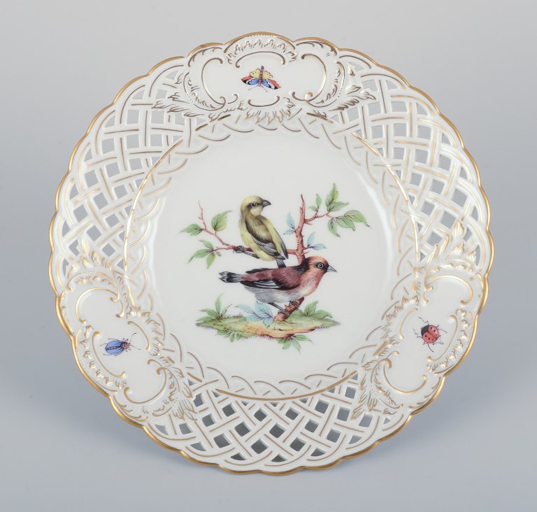 Meissen, Germany. Open lace porcelain plate. Hand-painted with a bird motif and insects, gold trim.