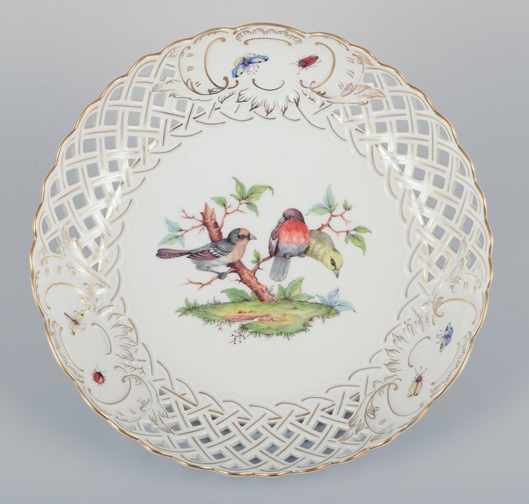 Meissen, Germany. Large open lace porcelain bowl. Hand-painted with a bird motif and insects, gold trim.