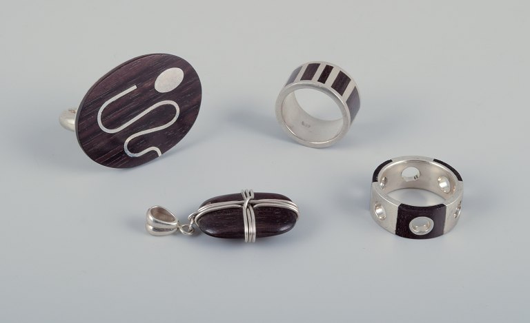 Swedish jewelry artist. Three rings and a pendant in sterling silver and dark wood.