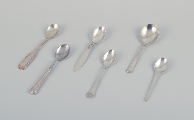 Georg Jensen, Cohr, and other Danish silversmiths.Five coffee spoons and a marmalade spoon in Sterling silver and 830 silver.