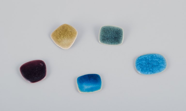 Ole Bjørn Krüger (1922-2007), Danish sculptor and ceramicist.Five unique brooches in glazed stoneware in blue, green, purple, and yellow shades.