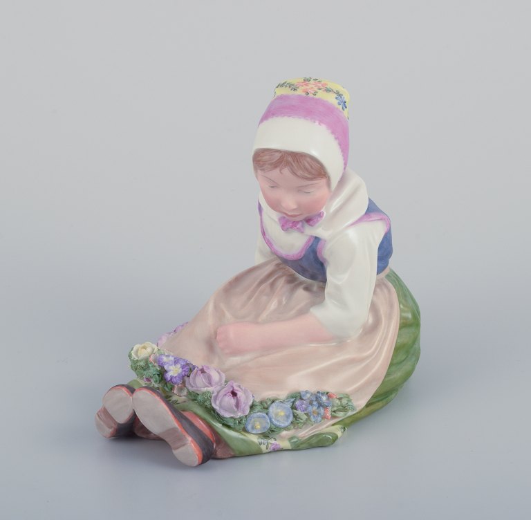 Royal Copenhagen, regional figurine of a girl from Zealand (Denmark). Overglaze. Dressed in regional costume and wearing a flower wreath.