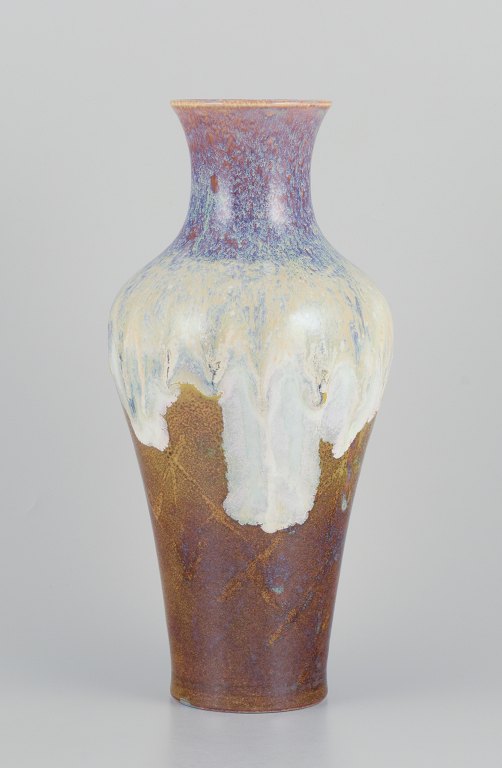 Sevres, France. Large unique porcelain vase with flowing glaze in ochre yellow, purple, and sand tones.