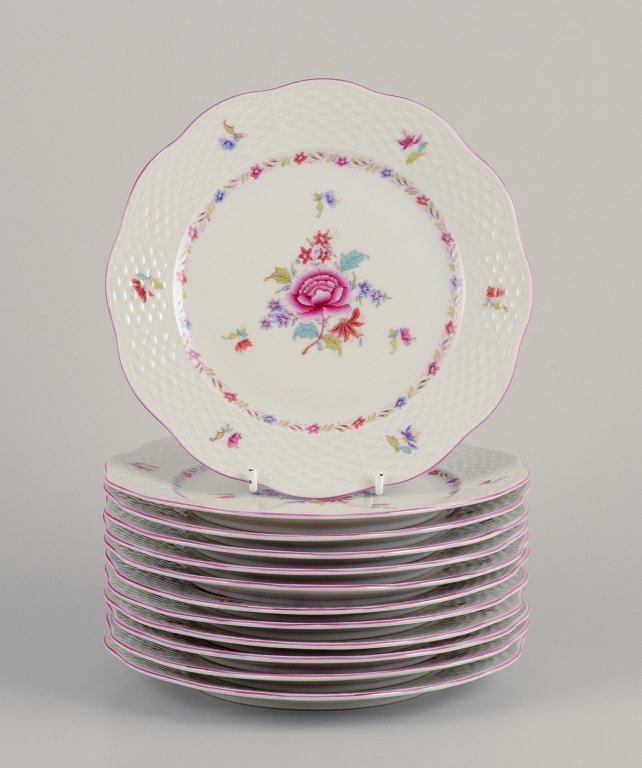 Herend, a set of twelve porcelain plates.Hand-painted with polychrome floral motifs.