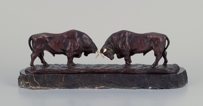 European sculptor.Bulls in combat.Art Deco sculpture in patinated bronze on a black marble base.
