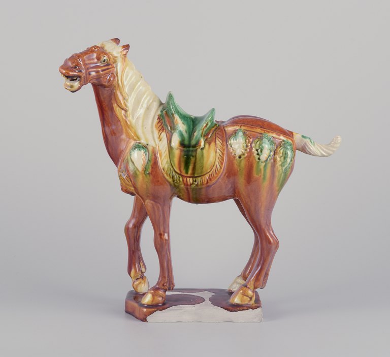 Chinese Tang horse in ceramic.Hand-glazed in brown and green shades.