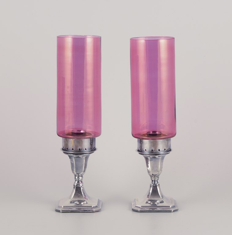 A.J. Pepper & Co. Ltd.Pair of "Hurricanes" candlesticks in silver and violet glass.