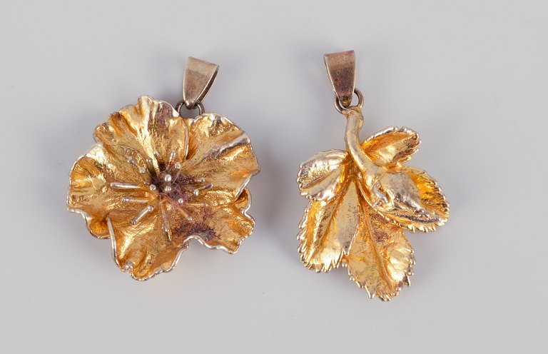 Flora Danica Jewellery, produced by Eggert. Two flower pendants in gold-plated sterling silver.