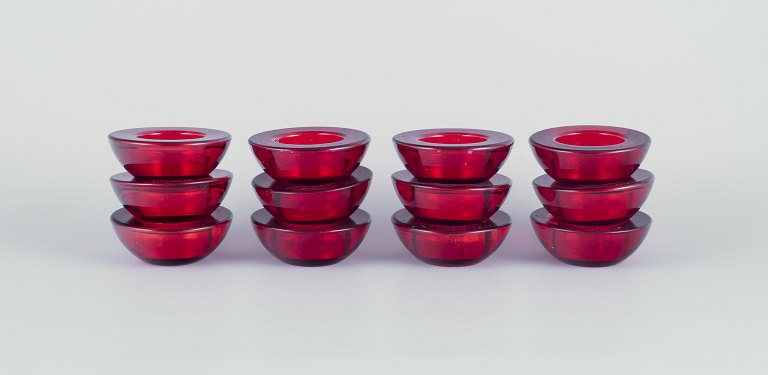 Scandinavian glass artist. A set of twelve candle holders.