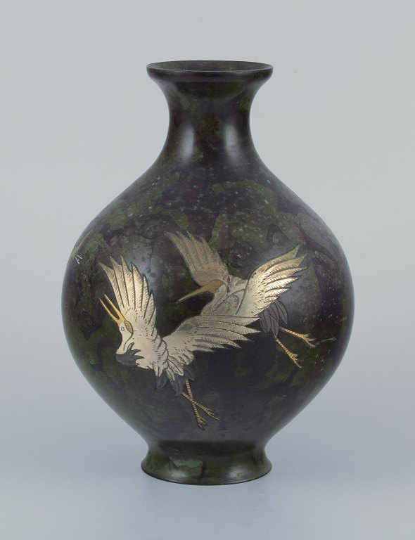 Japan, large round vase in brass.Motif of cranes in silver.