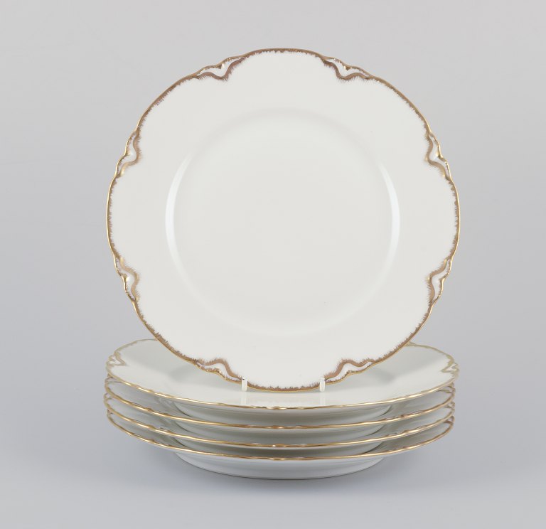 A set of five ‘Haviland’ porcelain dinner plates.Hand-decorated gold decoration, white porcelain.