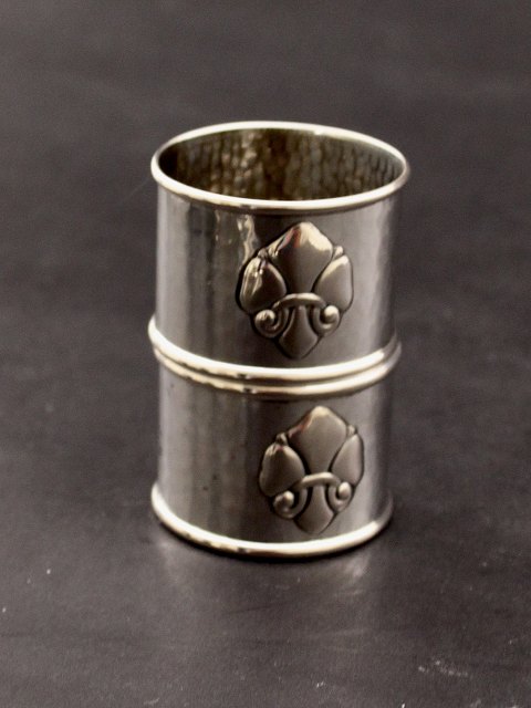 A pair of silver French lily napkin rings