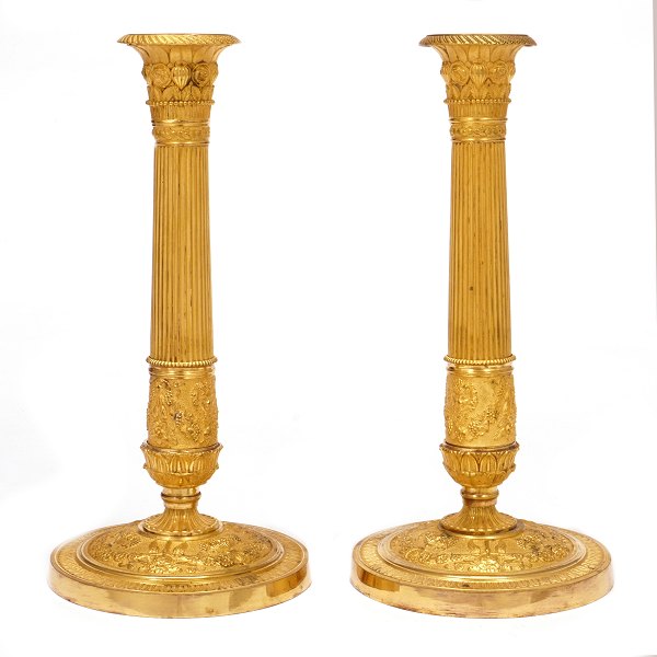 Pair of fire gilt Empire bronze candlesticks. France ca. 1810. H: 28cm