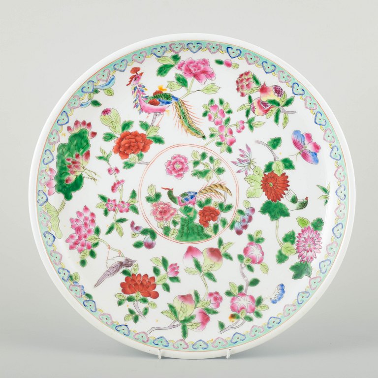 China, Tongzhi (1862–1874), 19th century.Large porcelain dish, decorated with flowers, fruits, and birds in famille rose enamels.